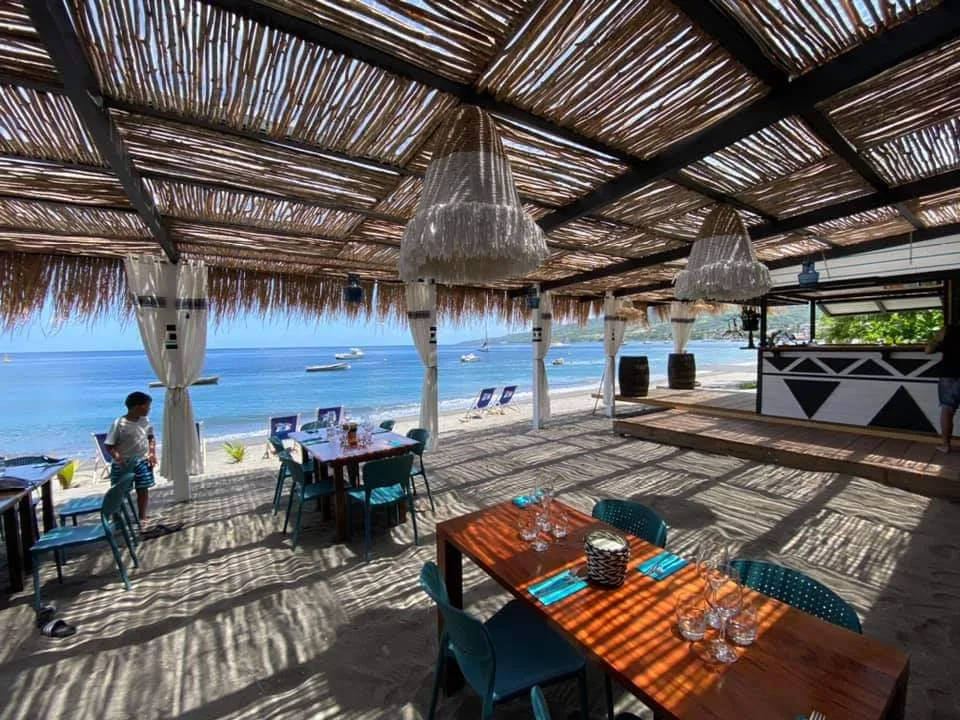 La terrasse sous la pergola, tables face à la mer